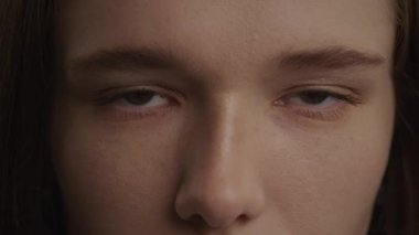 Close up of a caucasian woman open her eyes in 120 fps slow motion in front view