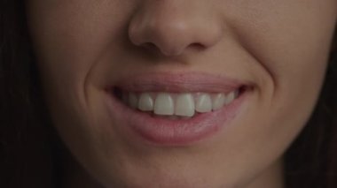 Close up of a caucasian woman confident toothy smile in slow motion