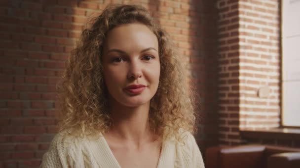 Portrait Young Adult Curly Caucasian Woman Looking Camera Smiling Loft — Stockvideo