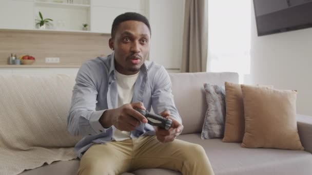 Young Adult Guy Playing Console Game Celebrates Win Indoors — Videoclip de stoc