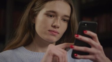 Close up of a caucasian woman double tap press with a single finger while browsing on a smart phone indoors