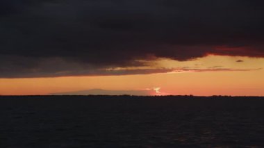 Fast camera pan over a scenic river with storm sky on sunset in slow motion outside