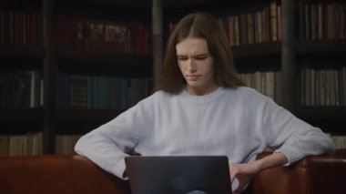 Caucasian woman working on a laptop computer indoors in slow motion