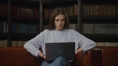 Caucasian woman working serious on a laptop indoors in slow motion