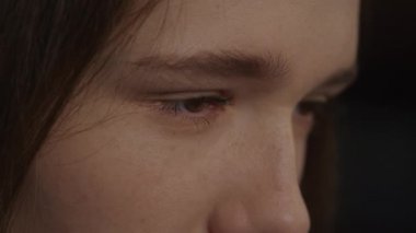 Close up of a caucasian woman open her eyes in slow motion in side view in slow motion