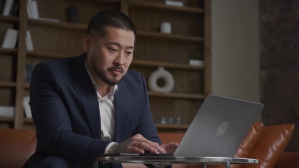 Låg Vinkel Porträtt Eftertänksam Asiatisk Affärsman Bläddrar Efter Möjligheter Sin — Stockvideo