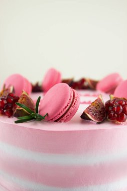 pink tasty Cake decorated with macaroons and fruits