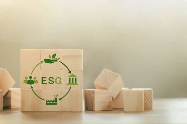 Yenilenebilir kaynak ekonomisinde ESG kavramı, geri dönüşüm, çevre, yeniden kullanım, üretim, sürdürülebilir kalkınma. Tahta blokta sembol simgesi olan