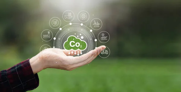 CO2 emission concept in farmers hands environmental icons global warming sustainable development and green business from renewable energy Clean and friendly environment without carbon dioxide emissions.