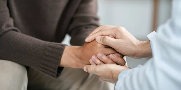 Male doctors shake hands with patients encouraging each other and praying for blessings. To offer love, concern, and encouragement while checking the patient\'s health. concept of medicine and health care