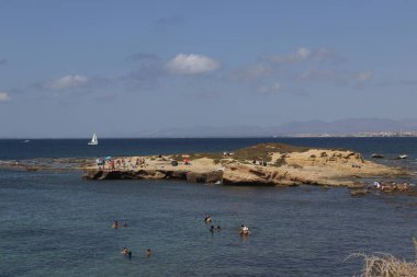 Tabarca, Alicante, Spain Agost 28th, 2022 A View of the beach in Tabarca Island. People are enjoying beautiful blue mediterranean sea in a sunny day