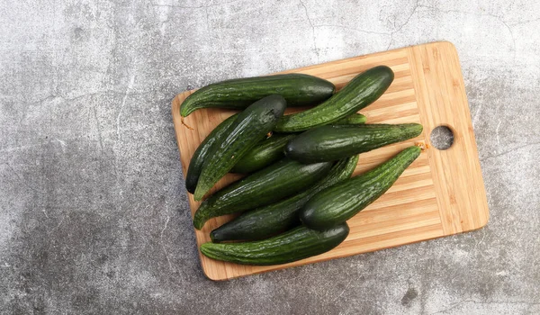 Fresh Small Cucumbers Rectangular Cutting Wooden Board Dark Grey Background — Stock Photo, Image