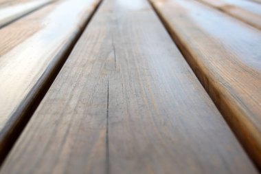 Tahta tahtaların perspektif görüntüsü. Parktaki banka yakın plan.