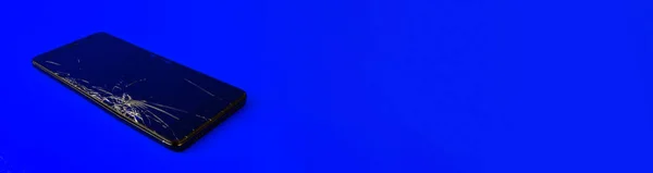 Мобильный Телефон Сломанным Экраном Лежит Синем Фоне Сломанный Смартфон Электронный — стоковое фото