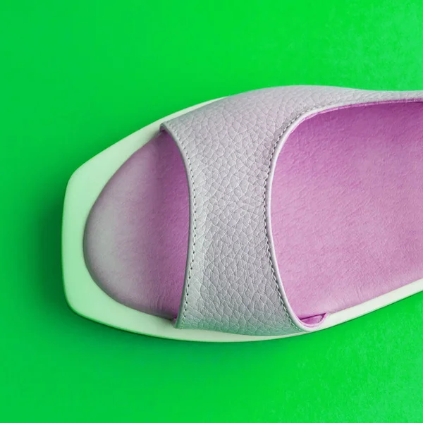 women\'s shoes purple on a green background. shoes are removed from above. Banner for insertion into site. horizontal shoes. Square image.