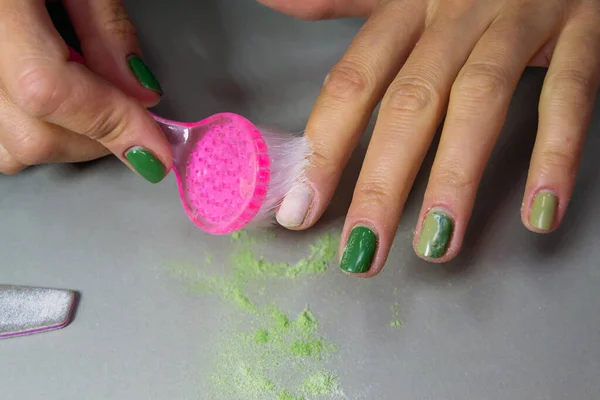 The process of cutting gel polish from female nails. home manicure. cleaning nails from dust. Horizontal image.