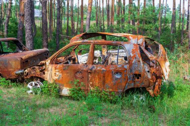 burnt cars. pile of scrap metal. consequences of the war. Irpin, Bucha, Gostomel