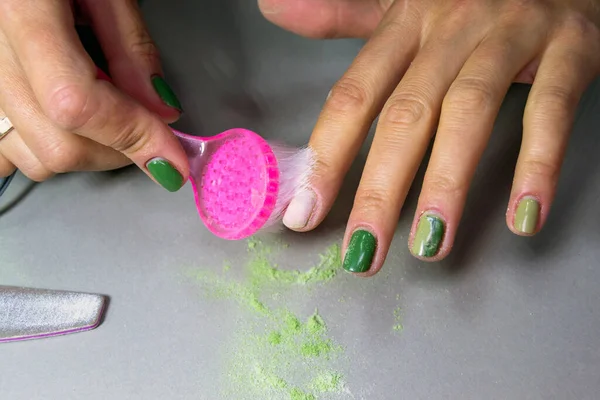 removal of green nail polish from a girl. home manicure. Horizontal image.