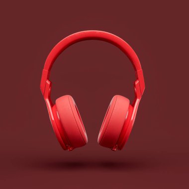 Kırmızı bir stüdyoda, kulaklığın üzerine tek renkli kırmızı bir kulaklık, ön manzara, 3D görüntüleme.
