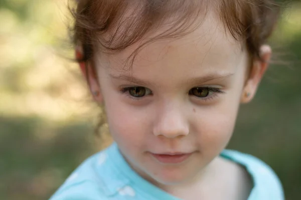 Портрет Красивой Молодой Девушки Голубой Футболке Размытом Зеленом Фоне Фотография — стоковое фото