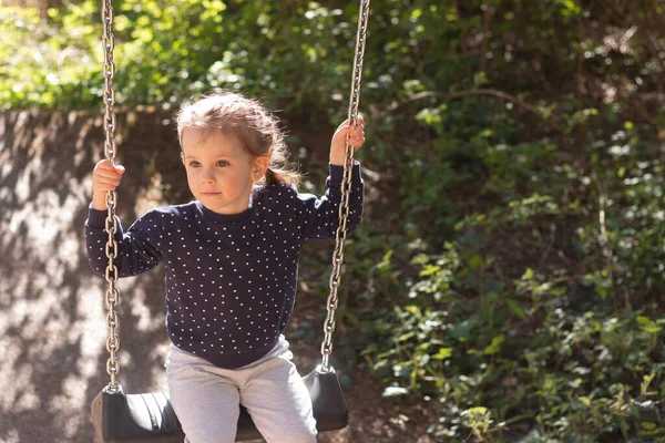 Little Beautiful Girl Smiling Swings Swing Park Background Blurred Foliage — Stockfoto