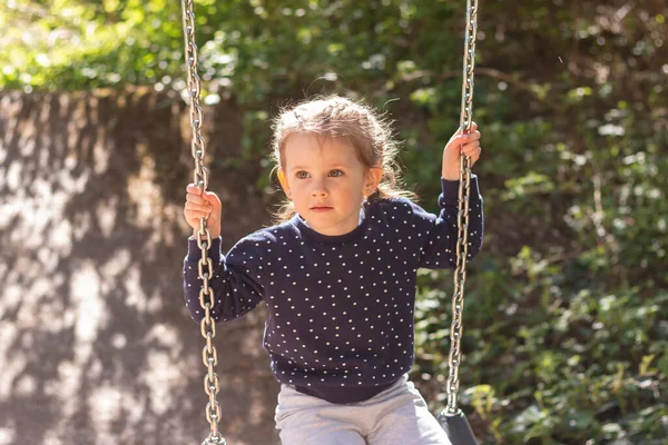 Little Cute Girl Smiling Swinging Swing Outdoors Background Blurred Foliage — Stockfoto