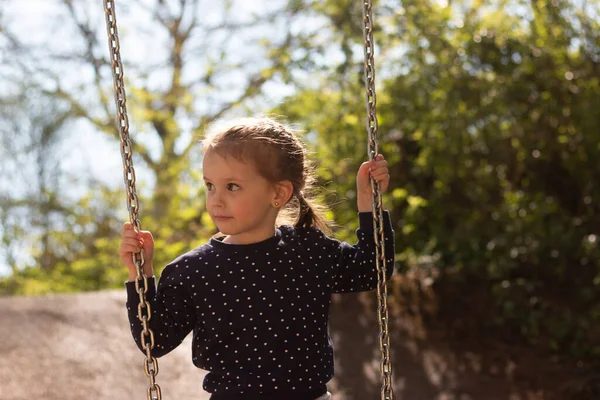 Little Serious Girl Braided Pigtails Rides Swing Park — Stockfoto