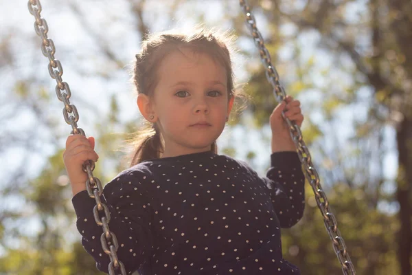 Little Serious Girl Braided Pigtails Rides Swing Park — Stockfoto