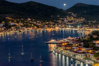 Night view with a full moon of  the picturesque port of Vathy village, the capital of Ithaca island, Ionian, Greece. clipart