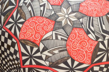 Soyut sembollü bir El boyalı seramik kürenin fotoğrafı.