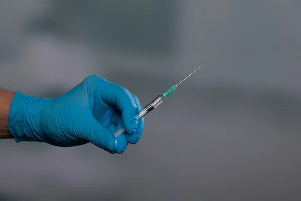 Close Doctor Hand Medical Gloves Syringe Vaccine Front Clinic Background — Fotografie, imagine de stoc