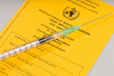 pass for international certificates of vaccination and a syringe 