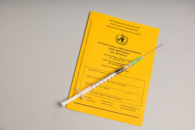 pass for international certificates of vaccination and a syringe 