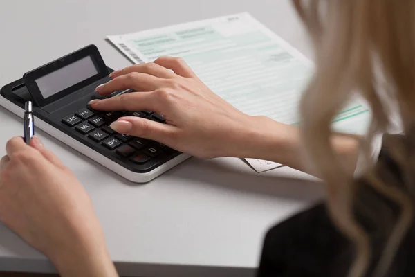 Close Woman Doing Tax Declaration Using Calculator — Fotografia de Stock