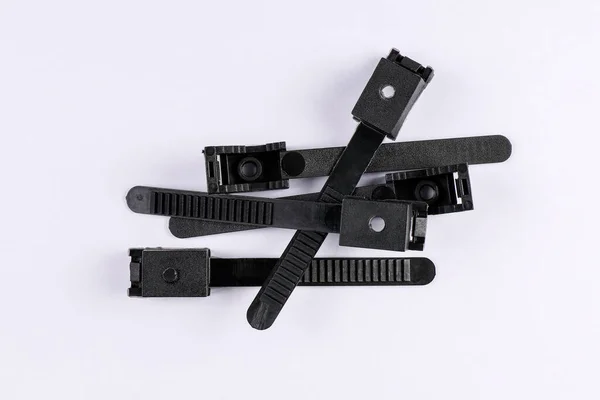 Black wire clamps on a white background — Stock Photo, Image