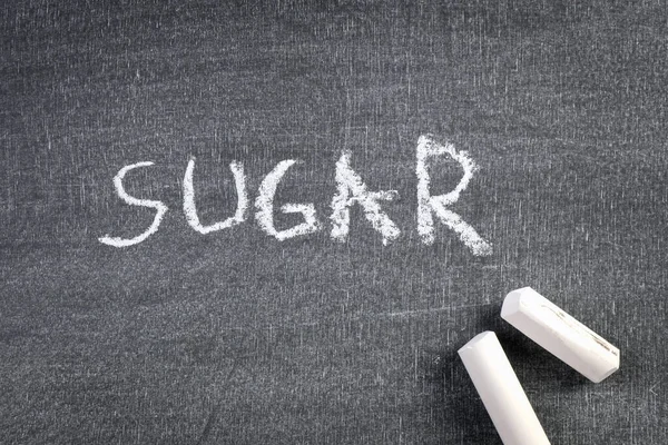 Azúcar Texto escrito en tiza blanca en una pizarra —  Fotos de Stock