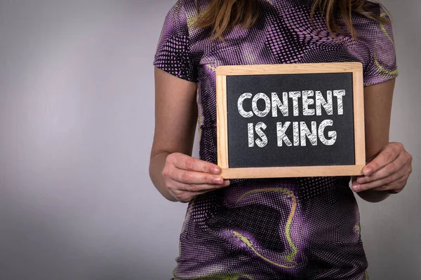 Content Is King. Woman holding a chalk board — Stock Photo, Image