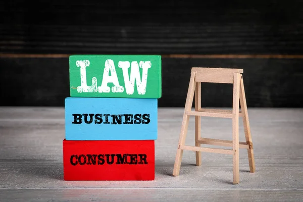 Consumer and Business Law concept. Colored wooden blocks in a pile and stairs — Fotografia de Stock