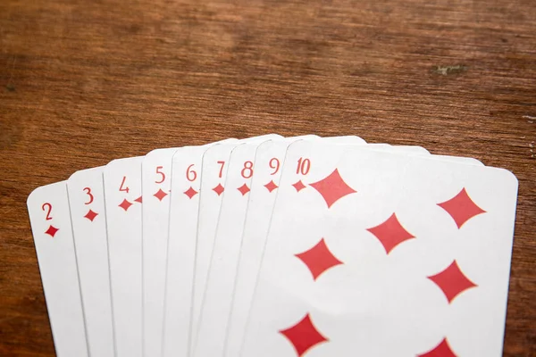 Playing cards with Diamonds from two to ten on a wooden background — Stockfoto