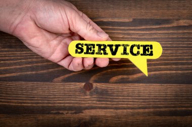 SERVICE. Yellow speech bubble on a dark wood texture background