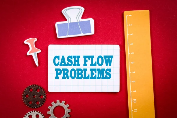Problemas de flujo de efectivo. Material de oficina y de aprendizaje sobre un fondo rojo —  Fotos de Stock