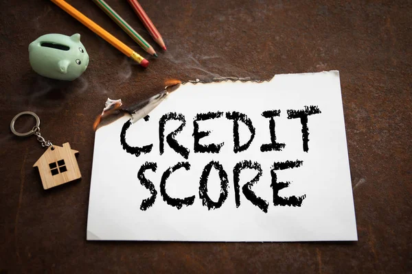 Credit Score concept. Burning sheet of paper with text — Stock Photo, Image