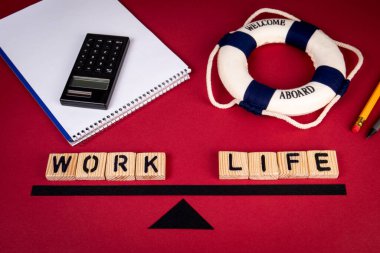 Work and Life balance concept. Office supplies on a red background