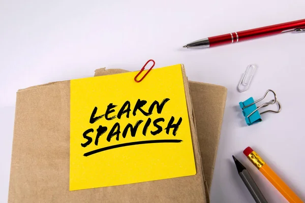 Learn Spanish. Textbooks and stationery on a white background —  Fotos de Stock