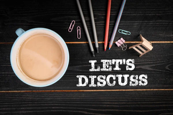 Lets Discuss. Coffee mug and office supplies on a wooden background — 스톡 사진