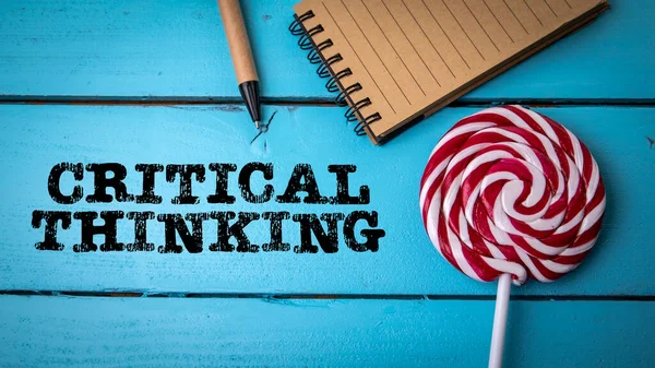 Critical thinking. Colored candy and office supplies on a wooden background — 스톡 사진