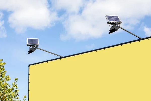 Yellow advertising banner. Led lighting and solar panels.