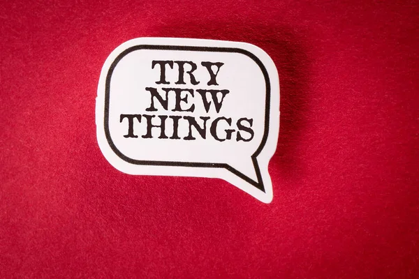 Try New Things. Speech bubble with text on red background.