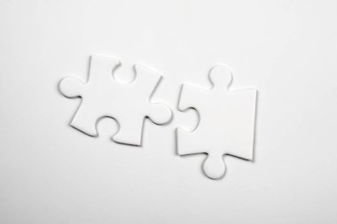 Two blank puzzle pieces on a white background. Skills and compatibility concept.