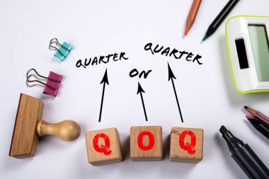 QOQ - Quarter On Quarter. White office desk.